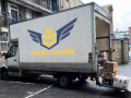 A Branded Removals Van being loaded in front of a council building